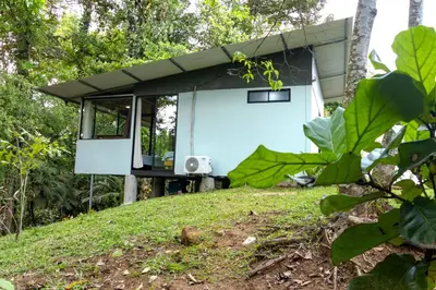 a house on top of a hill with trees at Chiri's Cabin in San Gerardo