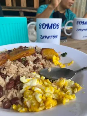 a plate of food on a table with a spoon at Somos Zapatón Catarata EL REY in Zapatón