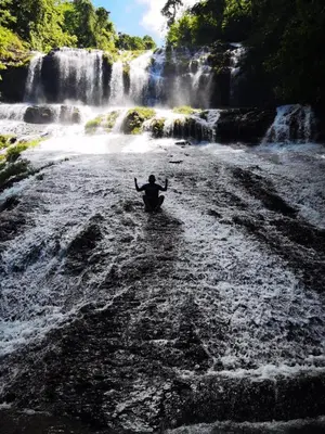 a person in a boat in front of a waterfall at Somos Zapatón Catarata EL REY in Zapatón