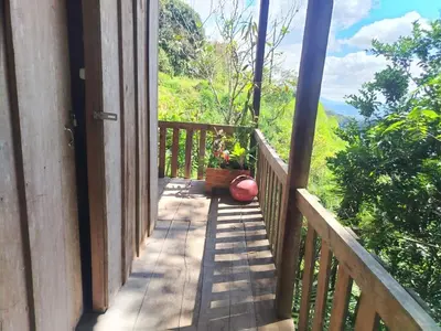 a wooden porch with a view of the mountains at Somos Zapatón Catarata EL REY in Zapatón