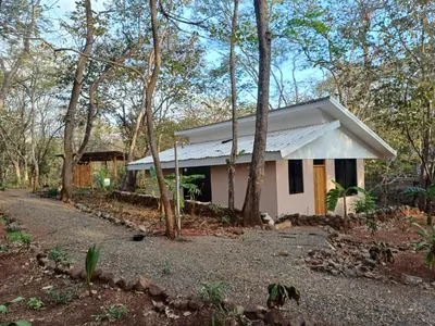 a small white house in the middle of trees at New casita walking distance to Avellanas beach in Río Sequito