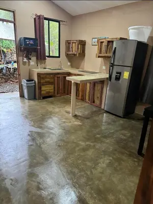 a kitchen with a counter and a refrigerator in it at New casita walking distance to Avellanas beach in Río Sequito
