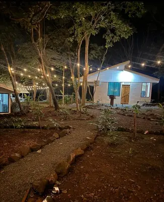 a house with lights in front of it at night at New casita walking distance to Avellanas beach in Río Sequito