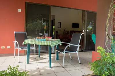 a table and chairs sitting on a patio at Apartments-Villas Playa Potrero 1 in Potrero