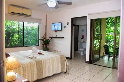 a bedroom with a bed with a towel on it at Apartments-Villas Playa Potrero 1 in Potrero