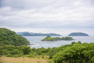 an island in a body of water with trees at Apartments-Villas Playa Potrero 1 in Potrero