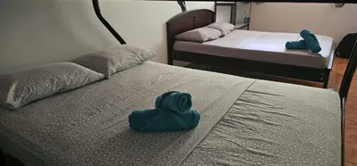 a room with two beds with a blue blob on the bed at Cabaña y Piscina el Lorito in Uvita