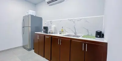 a kitchen with a sink and a refrigerator at Forest apartments studio F3, walking to the beach! in Jacó