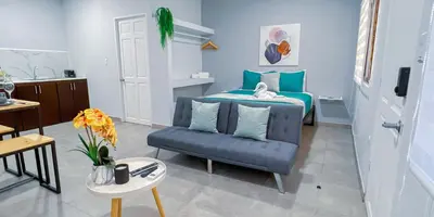 a bedroom with a bed and a couch and a table at Forest apartments studio F3, walking to the beach! in Jacó