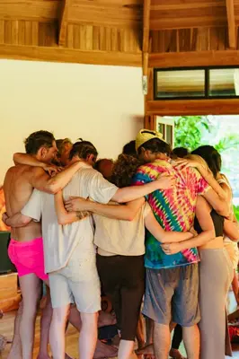 a group of people hugging each other at Awake Uvita in Uvita