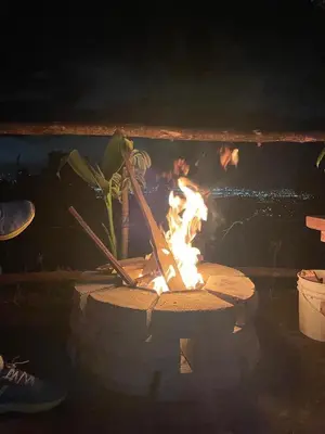 a fire in a brick oven with people in it at Mountain Chalet with Valley View in Alajuela City