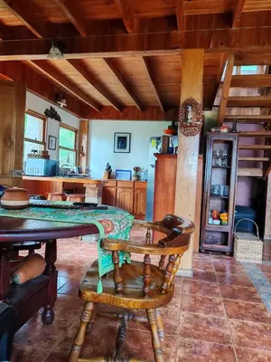 a kitchen with a table and chairs in a room at Mountain Chalet with Valley View in Alajuela City