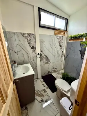 a bathroom with a toilet and a sink at Mini Casa Aura in Fortuna