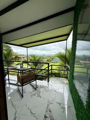 a view of a patio with a table and bench at Mini Casa Aura in Fortuna