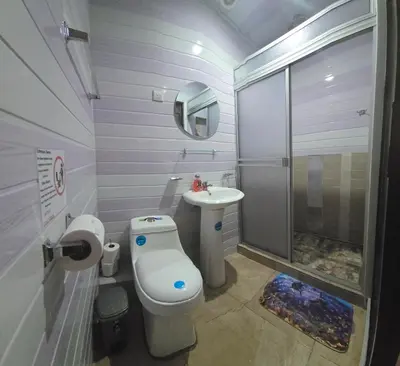 a small bathroom with a toilet and a sink at Apartamentos Cabo Verde B1 in Uruca