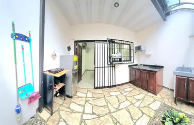 a kitchen with a gate in the middle of a room at Apartamentos Cabo Verde B1 in Uruca