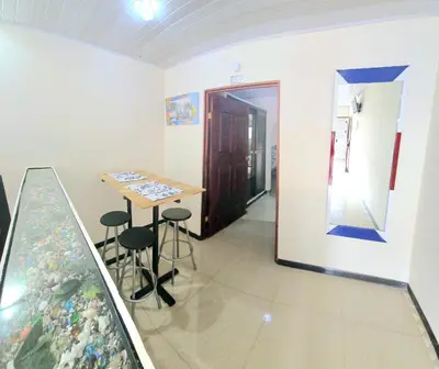 a room with a table and two stools in it at Apartamentos Cabo Verde B1 in Uruca