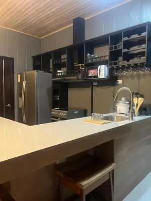 a kitchen with a sink and a refrigerator at Casa Briana in Uvita