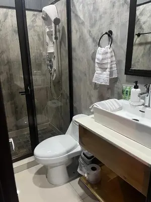 a bathroom with a toilet and a sink and a shower at Casa Briana in Uvita