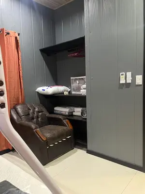 a room with a brown chair in a closet at Casa Briana in Uvita