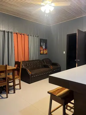 a living room with a couch and a table at Casa Briana in Uvita