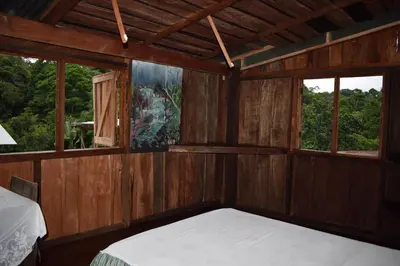 a room with a bed and two windows at Mirador Prendas in Sarapiquí