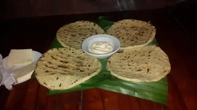 a plate of bread with a bowl of butter at Mirador Prendas in Sarapiquí
