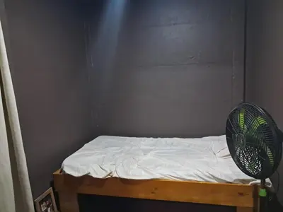 a room with a bed with a fan on it at Casa Lilly in Pejibaye
