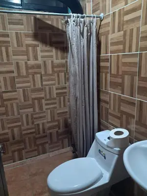 a bathroom with a toilet and a sink at Casa Lilly in Pejibaye