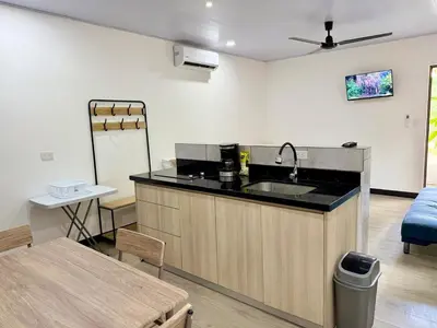 a kitchen with a sink and a counter top at Punta Leona, beach 5mn,gated parking, AC, TV, WiFi in Quebrada Ganado