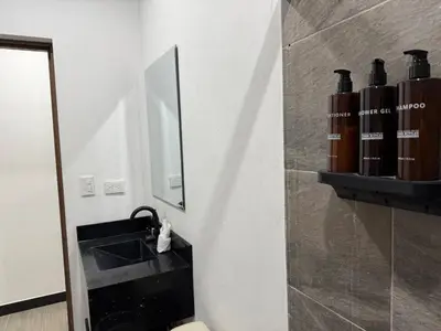 a bathroom with a sink and a mirror at Punta Leona, beach 5mn,gated parking, AC, TV, WiFi in Quebrada Ganado