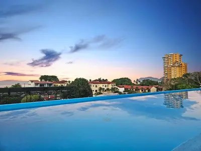 a swimming pool with a view of a city at Luxury Villa with rooftop infinity pool and walk away from the beach in Jacó