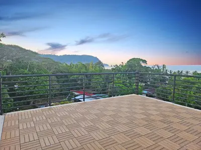 a balcony with a view of the mountains at Luxury Villa with rooftop infinity pool and walk away from the beach in Jacó