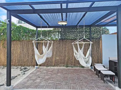 two hammocks hanging from a pergola at Luxury Villa with rooftop infinity pool and walk away from the beach in Jacó