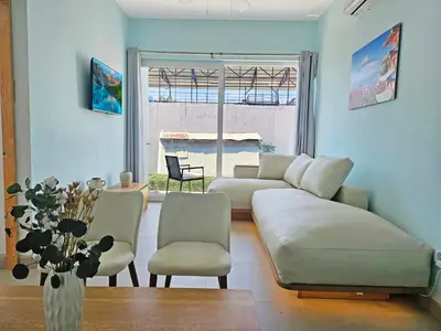 a living room with a white couch and chairs at Luxury Villa with rooftop infinity pool and walk away from the beach in Jacó