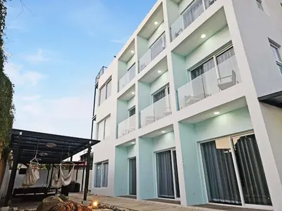 an apartment building with blue and white at Luxury Villa with rooftop infinity pool and walk away from the beach in Jacó