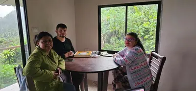 a group of people sitting at a table in a room at Casa Roncha Hospedaje in Turrialba