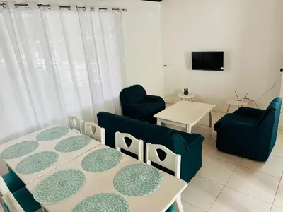 a living room with two tables and a couch at Casa Pura Vida in Puntarenas