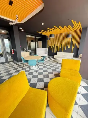 a lobby with yellow furniture and a table and chairs at Great View in Escalante! in San José