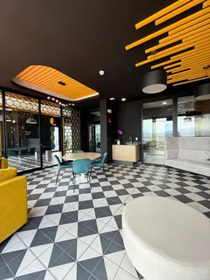 a lobby with a table and chairs in a building at Great View in Escalante! in San José