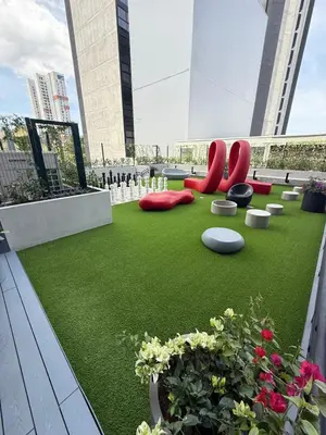 a rooftop garden with red chairs and flowers on a building at Great View in Escalante! in San José