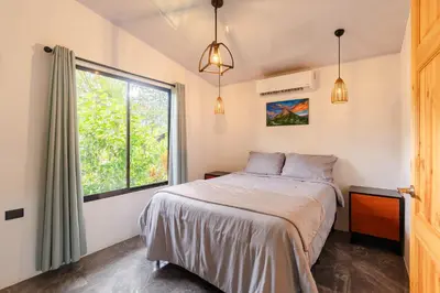 a bedroom with a bed and a window at Villa Tucán Fortuna in Fortuna