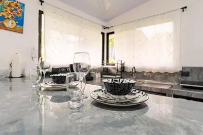 a table with wine glasses and plates on it at Villa Tucán Fortuna in Fortuna