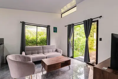 a living room with a couch and a table at Villa Tucán Fortuna in Fortuna