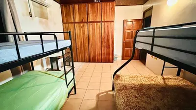 a bedroom with two bunk beds in a room at Hostel la perla in Puntarenas
