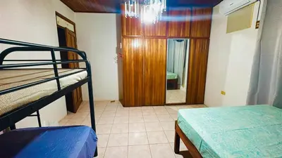 a room with two bunk beds and a mirror at Hostel la perla in Puntarenas
