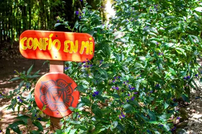 a sign that says corolla sun in front of a bush at Hotel Holístico Monteverde in Monteverde Costa Rica