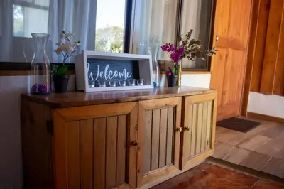 a laptop computer sitting on top of a wooden cabinet at Hotel Holístico Monteverde in Monteverde Costa Rica