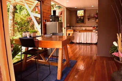 a kitchen with a wooden table in a room at Natural - cabin, 30 min Fortuna, wifi 200mb in San Pedro