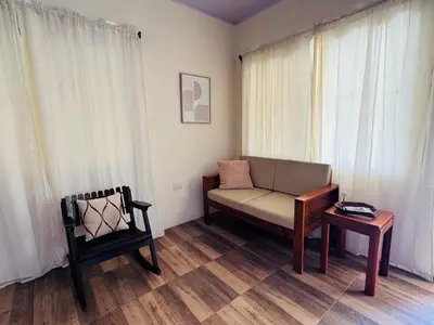 a living room with a couch and a chair at Casa De Daniel in Daniel Flores